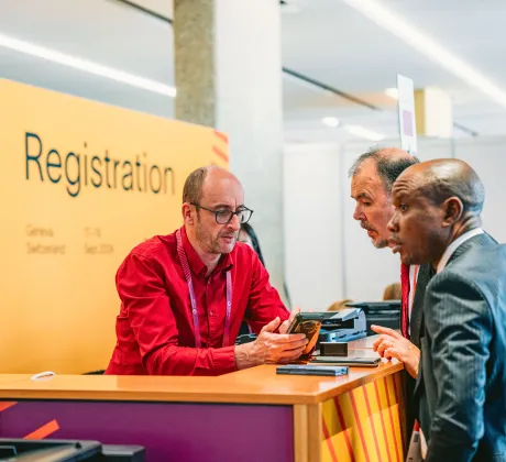 People at the registration desk at the 2022 World Cancer Congress