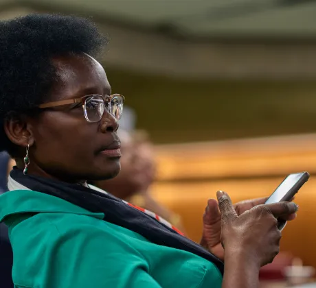 Woman holding her phone at a workshop at the World Cancer Congress 2022
