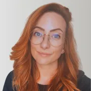 A headshot of a red head woman
