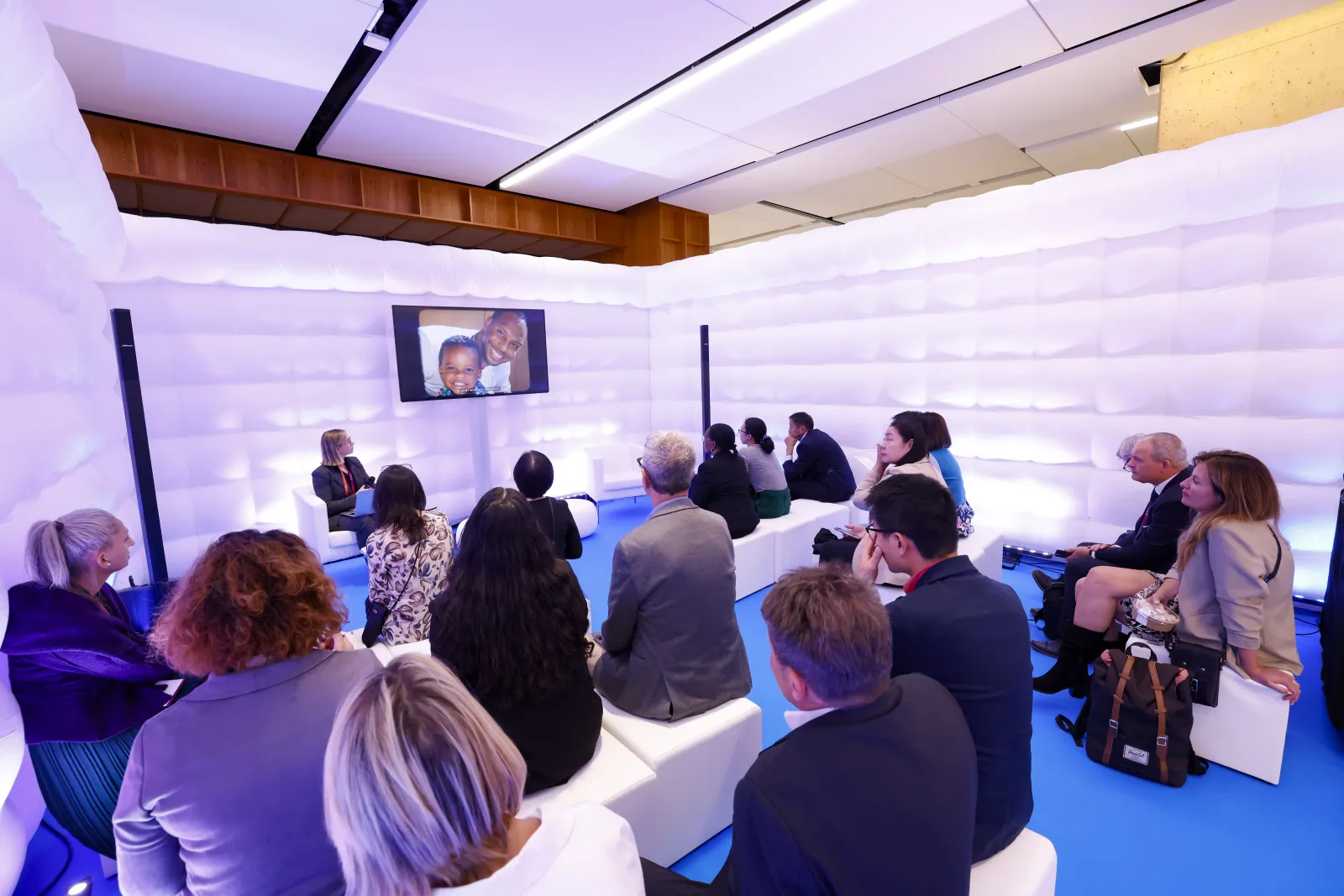People attending a session at one of the stages in the Global Village at the 2024 WCC