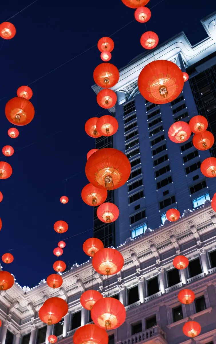 Lit lanterns hanging in the street during the night in Hong Kong